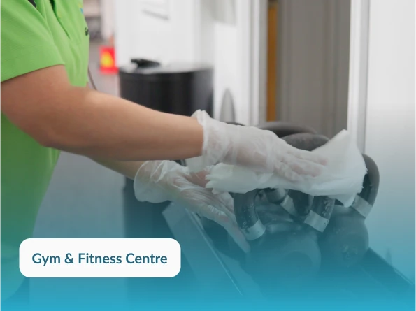 GleamClean WA cleaner sanitising gym equipment in Perth – hygiene-focused commercial cleaning for fitness centres.
