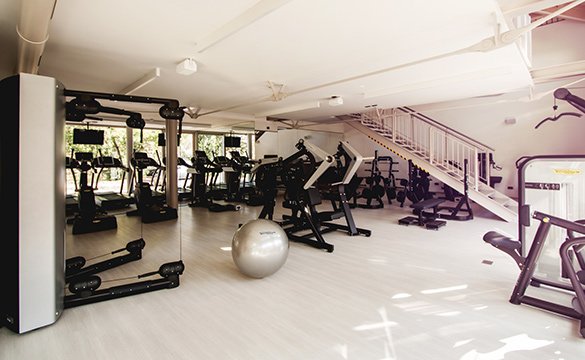 Modern gym with exercise machines, treadmills, and fitness equipment in a clean, well-lit space.