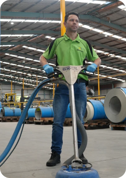 GleamClean WA team member using professional floor cleaning equipment in Perth warehouse – contact us for a free cleaning estimate.